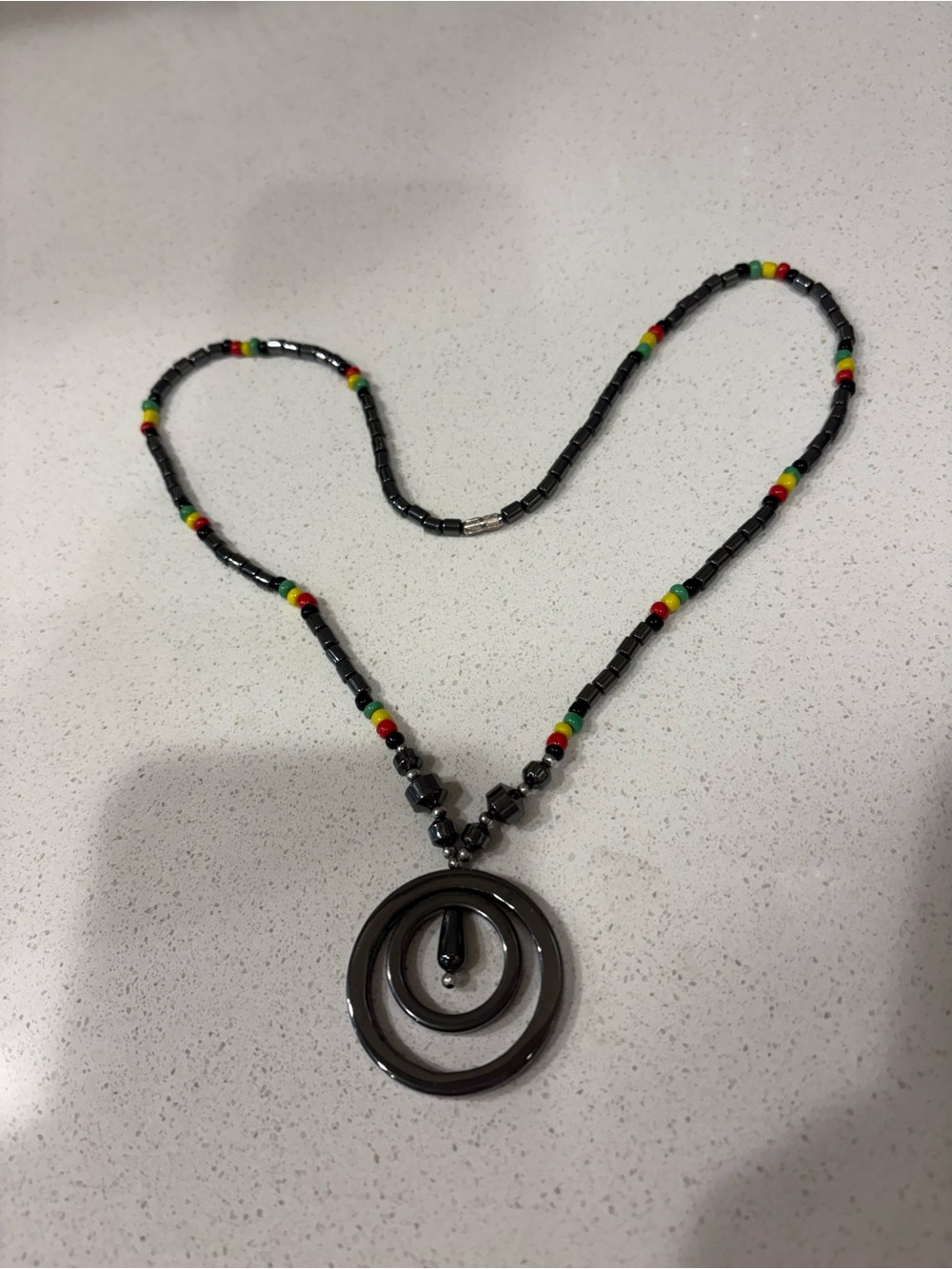 Elegant Hematite Circle Pendant Necklace with Black and Rasta Accent Beads